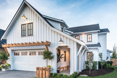 Example of a farmhouse white two-story mixed siding exterior home design in Vancouver with a shingle roof