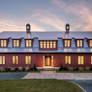 Country red two-story wood house exterior idea in Richmond with a gambrel roof and a metal roof