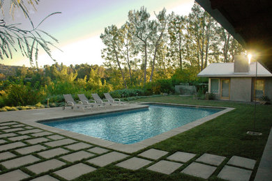 Pool - large contemporary backyard concrete paver and l-shaped pool idea in Los Angeles