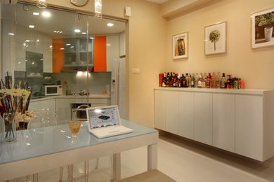 Kitchen/dining room combo - small modern porcelain tile kitchen/dining room combo idea in Singapore with beige walls and no fireplace