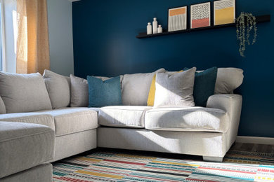 Example of a mid-sized eclectic look-out laminate floor and gray floor basement design in Milwaukee with blue walls