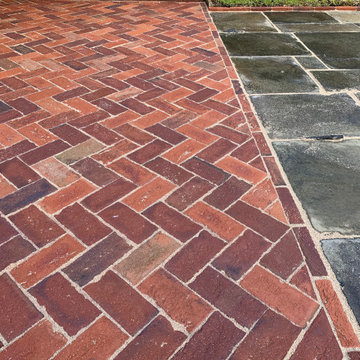 Reclaimed Yorkstone terrace with herringbone brick path