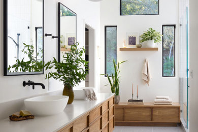 Example of a large trendy master white tile and porcelain tile terrazzo floor, gray floor, double-sink and vaulted ceiling bathroom design in Other with furniture-like cabinets, medium tone wood cabinets, a one-piece toilet, white walls, a vessel sink, quartzite countertops, white countertops, a niche and a floating vanity