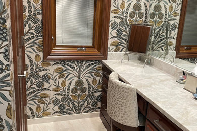 Photo of a bathroom in Other with wallpapered walls.