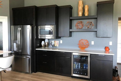 Inspiration for a small contemporary kitchen remodel in Other with an undermount sink, flat-panel cabinets, dark wood cabinets, stainless steel appliances and an island