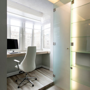 Inspiration for a small modern study in Palma de Mallorca with white walls and a built-in desk.