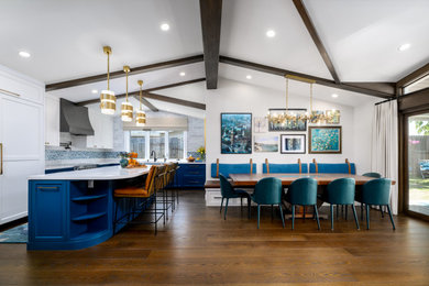 Eat-in kitchen - large contemporary l-shaped dark wood floor, brown floor and exposed beam eat-in kitchen idea in Santa Barbara with an undermount sink, shaker cabinets, blue cabinets, quartz countertops, blue backsplash, glass tile backsplash, stainless steel appliances, an island and white countertops