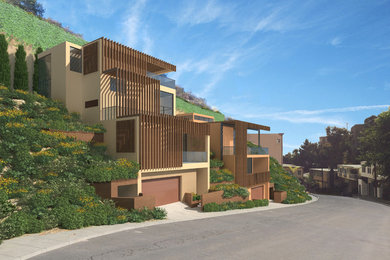 Mid-sized minimalist brown two-story stucco exterior home photo in Los Angeles