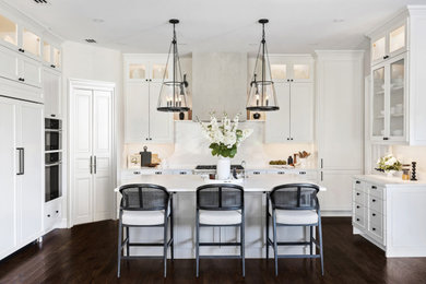 Kitchen - large transitional dark wood floor kitchen idea in Dallas with an undermount sink, white cabinets, quartz countertops, black appliances and an island