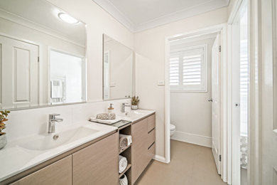 Design ideas for an expansive contemporary master bathroom in Sydney with furniture-like cabinets, beige cabinets, a hot tub, a curbless shower, white tile, ceramic tile, white walls, ceramic floors, an integrated sink, limestone benchtops, beige floor, a hinged shower door and white benchtops.