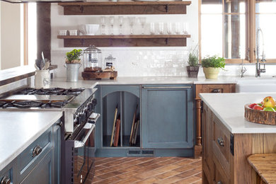 Eat-in kitchen - large farmhouse u-shaped eat-in kitchen idea in Denver with a farmhouse sink, shaker cabinets, granite countertops, white backsplash, ceramic backsplash and an island