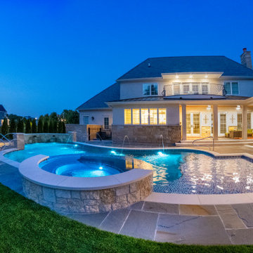 Naperville, IL freeform swimming pool with hot tub, large sunshelf, glass tile