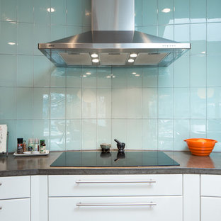 Large midcentury modern kitchen pantry appliance - Large 1950s u-shaped medium tone wood floor kitchen pantry photo in Birmingham with an undermount sink, flat-panel cabinets, white cabinets, concrete countertops, blue backsplash, glass tile backsplash, stainless steel appliances and an island