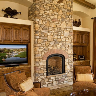 Photo of a large mediterranean formal open plan living room in Los Angeles with beige walls, porcelain flooring, a two-sided fireplace, a stone fireplace surround and a built-in media unit.
