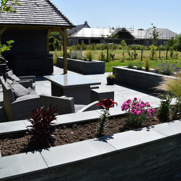 Patio with raised beds and specimen planting.