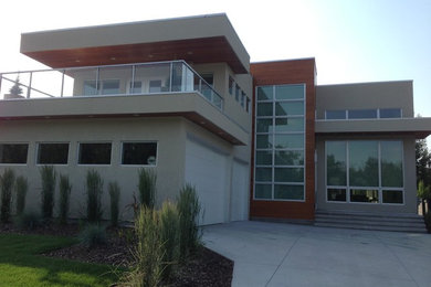 Inspiration for a mid-sized beige two-story wood flat roof remodel in Edmonton