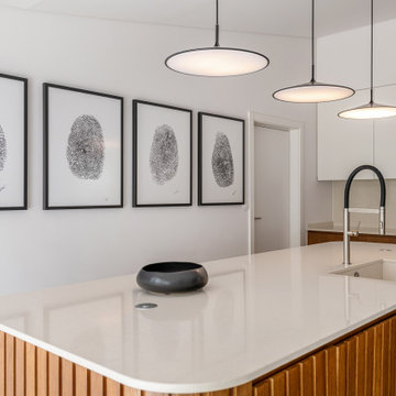 Kitchen island with white countertop and pendant lights, Alfragide