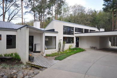 Inspiration for a large modern white two-story stucco exterior home remodel in Grand Rapids