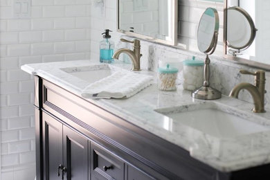 Example of a trendy white tile and subway tile porcelain tile and white floor bathroom design in Orlando with recessed-panel cabinets, dark wood cabinets, blue walls, an undermount sink, quartzite countertops and a two-piece toilet