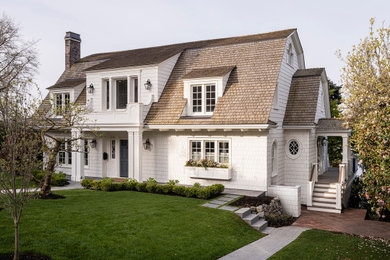 Traditional three-story wood and shingle house exterior idea in Seattle with a shingle roof