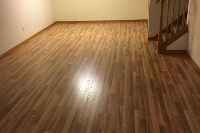 Living room - mid-sized contemporary formal and open concept laminate floor and yellow floor living room idea in Minneapolis with white walls and no tv