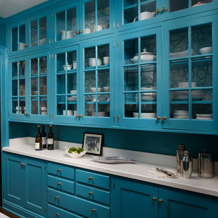 Photo of a mid-sized transitional galley kitchen pantry in Chicago with glass-front cabinets, blue cabinets, quartzite benchtops, white splashback and dark hardwood floors.