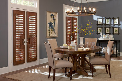 Mid-sized elegant dark wood floor and brown floor enclosed dining room photo in New York with gray walls and no fireplace
