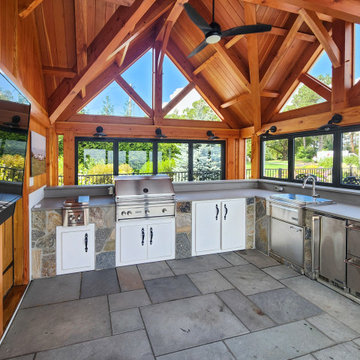 Post-and-Beam Outdoor Kitchen Wrapped in NanaWall Glass on Three Sides
