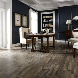 This is an example of a mid-sized traditional study room in Other with black walls, medium hardwood floors, no fireplace, a freestanding desk and brown floor.