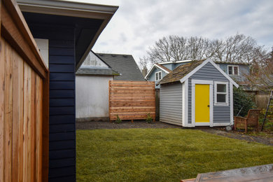 Photo of a mid-sized privacy wood fence landscaping in Portland.