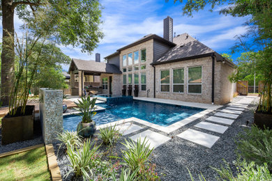 Inspiration for a mid-sized modern backyard stone pool landscaping remodel in Houston