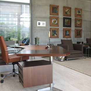 Photo of a large modern study room in Other with travertine floors and a freestanding desk.