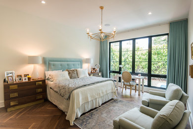 Example of a mid-sized trendy master medium tone wood floor and brown floor bedroom design in Orlando with beige walls and no fireplace