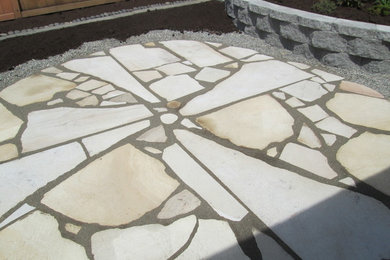 This is an example of a mid-sized traditional backyard garden in Seattle with natural stone pavers.