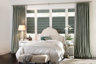 Example of a mid-sized beach style dark wood floor bedroom design in Other with white walls and no fireplace