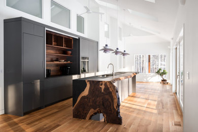 Beige floor kitchen photo in Boston with flat-panel cabinets, gray cabinets, wood countertops and an island