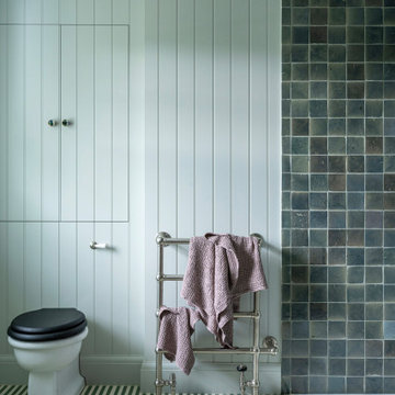 Ensuite bathroom with panelled walls and zellige tiles