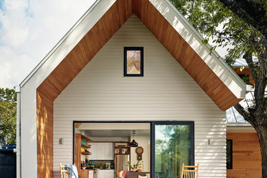 This is an example of a small scandinavian back porch design in Austin with decking and a roof extension.