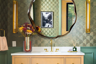 Powder room - contemporary mosaic tile floor, multicolored floor, wallpaper ceiling and wallpaper powder room idea in New York with furniture-like cabinets, light wood cabinets, green walls, quartz countertops, white countertops and a freestanding vanity