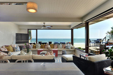 Example of a beach style living room design in Los Angeles with white walls
