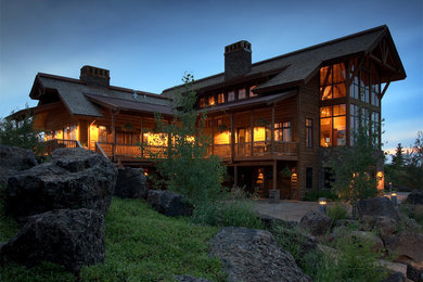 Inspiration for a large rustic brown three-story wood gable roof remodel in Other