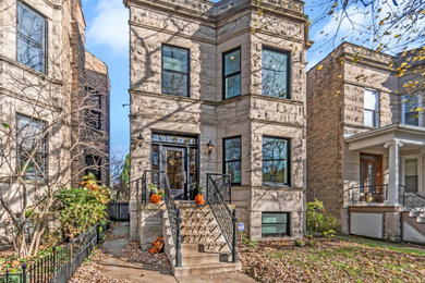 Large transitional gray two-story stone exterior home photo in Chicago