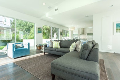 Example of a huge trendy open concept medium tone wood floor living room design in Tampa with white walls