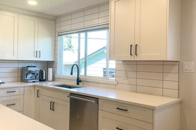 Example of a mid-sized transitional l-shaped marble floor and white floor eat-in kitchen design in Calgary with a double-bowl sink, shaker cabinets, white cabinets, quartzite countertops, white backsplash, stainless steel appliances, an island and white countertops