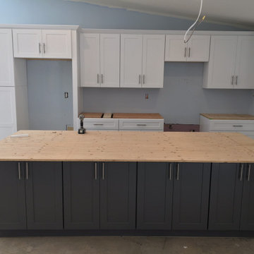 Kitchen white shaker upper cabinets and dark grey shaker base cabinets