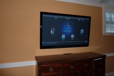 This is an example of a home cinema in Boston with a wall mounted tv.