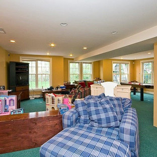 Design ideas for an expansive traditional walk-out basement in Boston with yellow walls, carpet and turquoise floors.