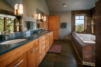 Bathroom - mid-sized contemporary master brown tile and ceramic tile concrete floor bathroom idea in Albuquerque with flat-panel cabinets, a one-piece toilet, an undermount sink, granite countertops, medium tone wood cabinets and beige walls
