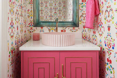 Small transitional mosaic tile floor, green floor and wallpaper powder room photo in Dallas with furniture-like cabinets, a two-piece toilet, multicolored walls, a vessel sink, quartz countertops, white countertops and a freestanding vanity