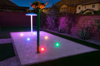 Photo of a large eclectic backyard garden for summer in Las Vegas with a water feature and concrete pavers.